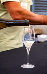 Fototapeta premium Tasting of vintage champagne sparkling wine on yearly Champagne festival in Cote des Bar, France, summer travel destination