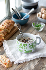 Delicious Cream of Mushroom soup in a cup served with crusty bread.