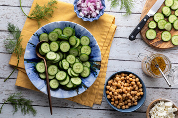 Fresh ingredients for making a healthy mini cucumber salad.