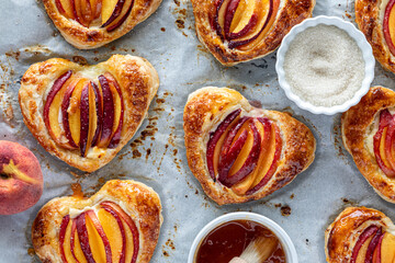 Heart shaped peach pastries with jelly glaze and sprinkled with sugar.