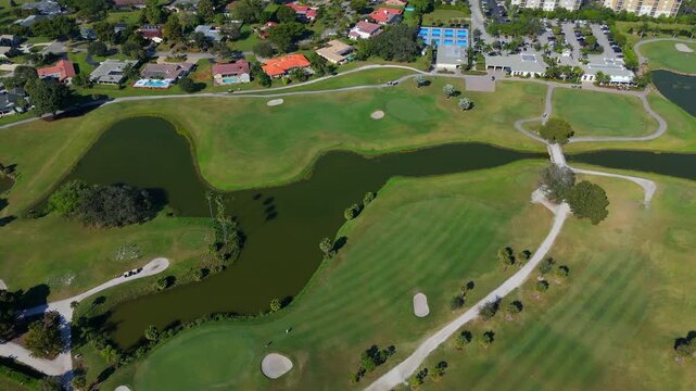 Wide aerial of Coral Springs Florida golf course with fairways ponds cart paths and bunkers on sunny day
