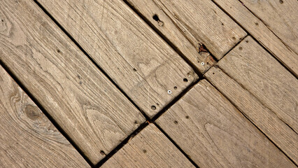 Fototapeta premium Diagonal Overhead View of Weathered Natural Wood Decking with Visible Grain and Knots Background Texture