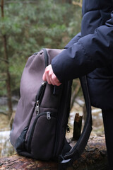 Obraz premium Male hands unfastening the zipper on a backpack. Touristic bag