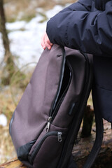Obraz premium Male hands unfastening the zipper on a backpack. Touristic bag