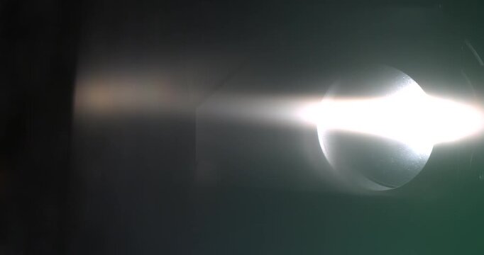 Slow motion, Dramatic Set Illuminated By Reflective Beams Manipulated Skillfully For Special Lighting Effects