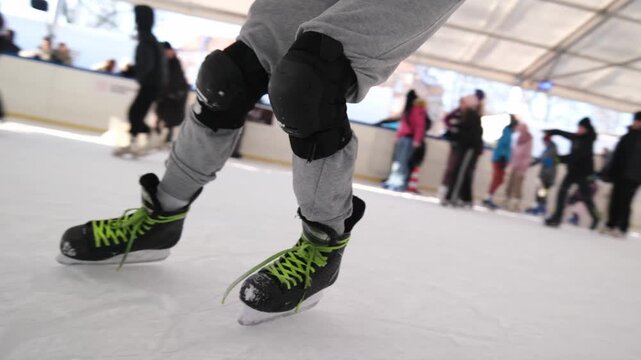 Young man performing inline skating tricks, riding backward with technical control