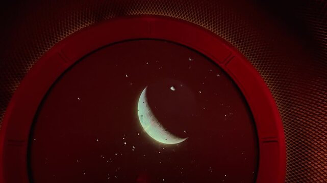 Visitors walk through a dark immersive tunnel with red lights, filming a crescent moon projection on a circular screen with their smartphones during a futuristic space exhibition tour.

