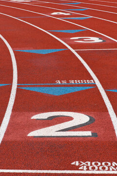 USA, WA, Seattle.  Lane numbers on high school sports field.