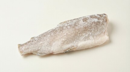 Obraz premium Raw Frozen White Fish Fillet Portion with Ice Crystals on White Background