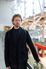 Obraz premium Man standing in modern transportation hub looking at camera