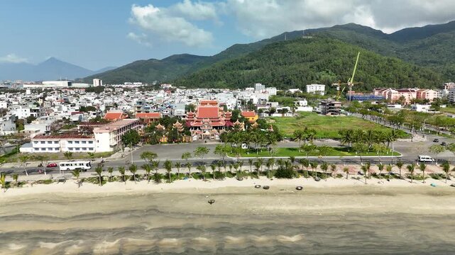 Buu Dai Son Pagoda, Da Nang, Vietnam &ndash; 4K aerial drone footage of Buddhist temple, coastal town and green mountain backdrop