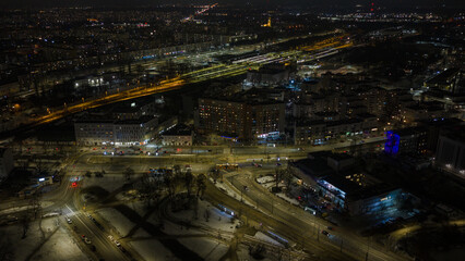 Fototapeta premium Nighttime aerial Warsaw Praga with snowy tram lines and Wschodnia tracks