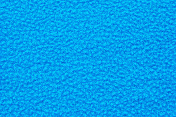 Fleece texture, a surface of blue fleece fabric as background © Irina