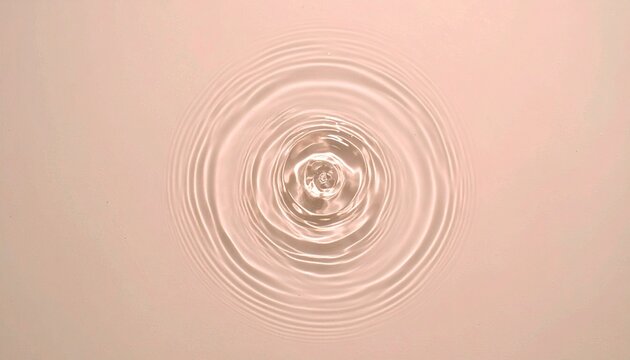 ピンクとグリーンのグラデーション背景に広がる水滴の波紋