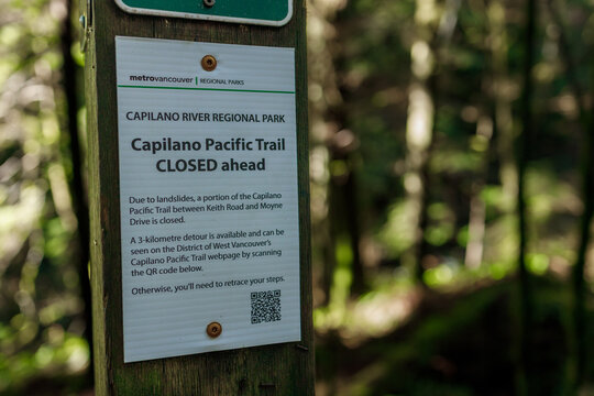 Metro Vancouver Regional Parks sign warning Capilano Pacific Trail closed ahead due to landslides