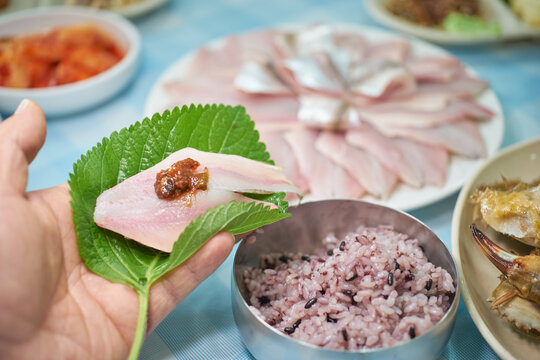 A plate of fresh 'Banji-hoe' (Raw Large-eyed Herring). Banji is a local specialty similar to Baendaengi but known for its richer taste and softer texture."