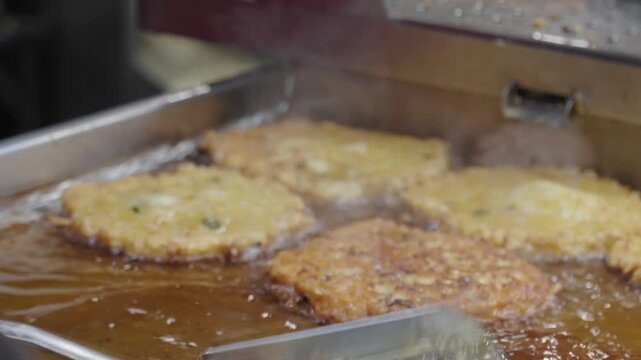Making bindae-tteok, a traditional Korean food, at the food corner of the market.