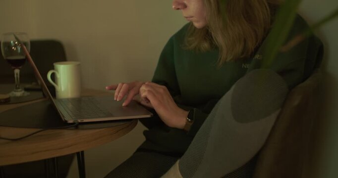 Woman working from home on laptop in cozy indoor workspace