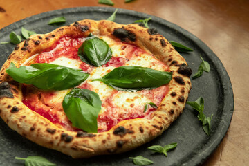 Authentic Neapolitan Margherita Pizza with Fresh Basil on Stone Plate
