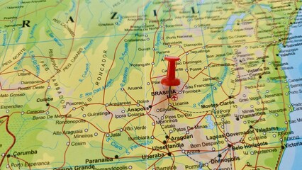 Naklejka premium View of Brasilia, Federal capital of Brazil, on a geographical map of America, marked with red push pin