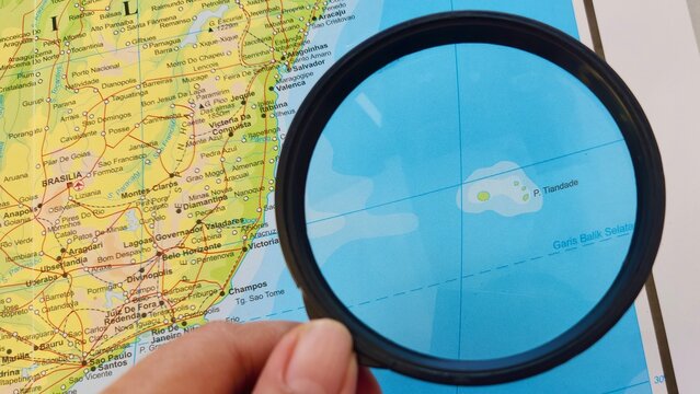 View of Trindade and Martim Vaz, Archipelago in Atlantic belonging to Brazil, on a geographical map of America, seen using a magnifying glass