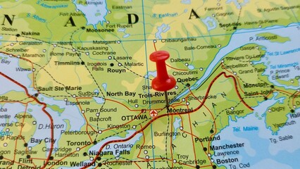 View of Montreal, is the largest city in the province of Quebec, the second-largest in Canada, and the ninth-largest in North America, on a geographical map of America, marked with red push pin