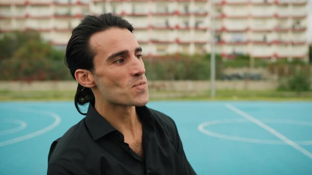 Man At The Basketball Court Tying His Hair And Preparing 