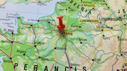 View of Paris, Capital city and largest city of France, on a geographical map of Europe, marked with red push pin © PinkyEn