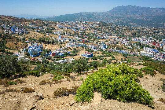 View of the outskirts of Chefchaouen, Morocco, with scattered houses on the slopes of the Rif mountains