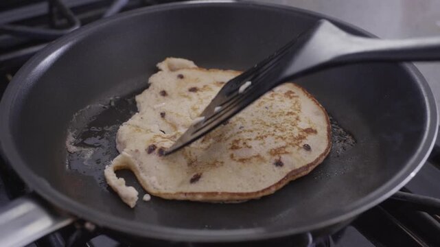 Flipping a pancake. Unsuccessfully turning a pancake around