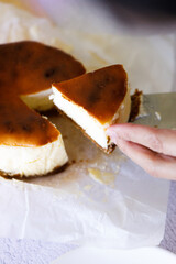 Cheesecake with baking paper on white marble table.