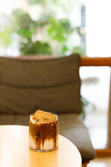 Iced latte coffee on top with biscuit.