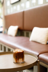 Iced latte coffee on top with biscuit.