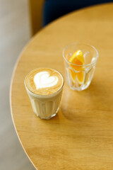 Cup of coffee latte art on wood table.