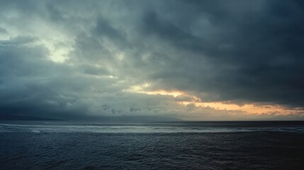 Fototapeta premium Seascape background featuring sunset, waves, and gloomy sky, for travel theme design, natural landscape