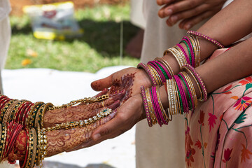 Close-up of Indian Bride and Groom Hands During Hastamelap Ritual during a wedding ceremony.