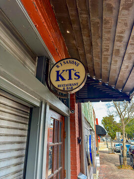 DOTHAN, ALABAMA - FEBRUARY 23, 2026: A circular hanging sign for KT's Bar and Grill, a local establishment in the downtown historic district.