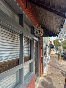 DOTHAN, ALABAMA - FEBRUARY 23, 2026: The rustic exterior of KT's Bar and Grill in downtown Dothan, showcasing a metal facade and wooden awning.