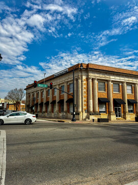 DOTHAN, ALABAMA - FEBRUARY 23, 2026: Exterior view of the historic building housing The Cochran Firm law offices, featuring grand columns and black awnings on Main Street.