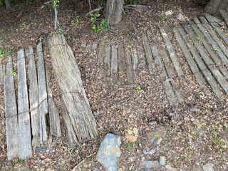 Wooden picket fence fallen over and lying decaying on the ground within the historic former gold mining township of Hill End