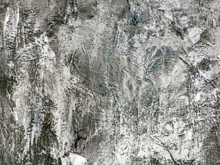 closeup of textured gray abstract background with layers of white and grey paint.