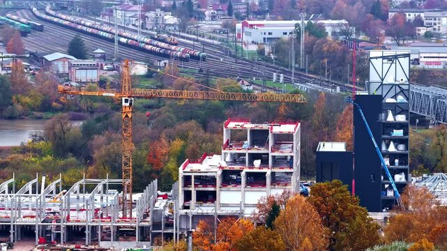 Aerial panorama of a development site with a tower crane and incomplete structures