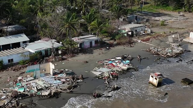 aerial shot small houses affected by the elevation of the ocean level for climate change