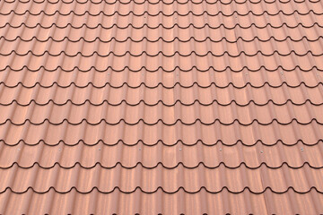 terracotta roof tile, repetitive waves pattern of brown roofing tile © andy0man