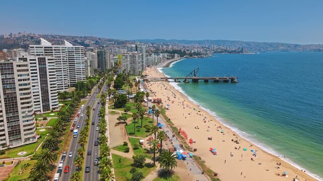 Aerial Panoramic fly Waterfront Boulevard Traffic, Beach, Buildings at Muelle Vergara Vina del Mar Chile