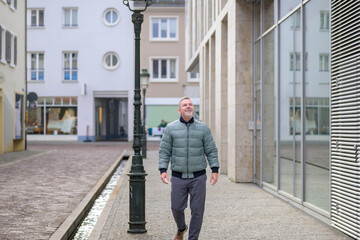 Senior man walking through city