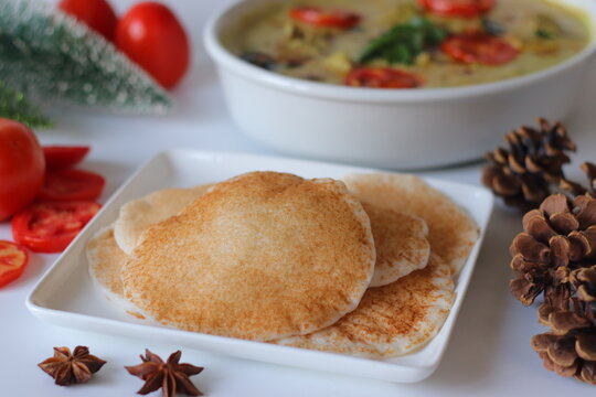 Kallappam, Kerala fermented rice pancakes made from rice batter fermented with yeast or toddy, served with chicken mappas in creamy coconut gravy. Authentic South Indian comfort food