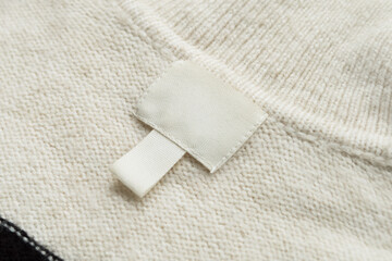 Obraz premium Blank White Clothing Label on Knitted Fabric