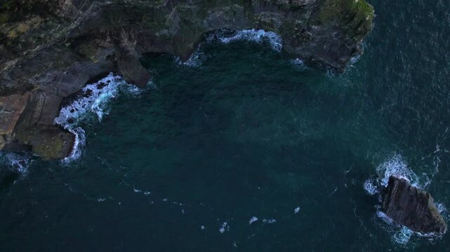 4K cinematic drone footage of O'Brien's Tower Cliffs of Moher, Ireland during a beautiful golden-hour sunset, showcasing dramatic coastal cliffs bathed in warm evening light. Ireland_067