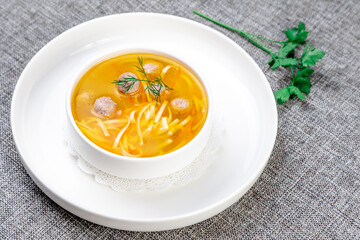 Classic Chicken Noodle Soup with Meatballs and Dill Garnish